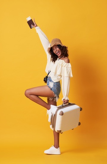 cheerful-young-african-woman-dressed-summer-clothes-holding-passport-with-money